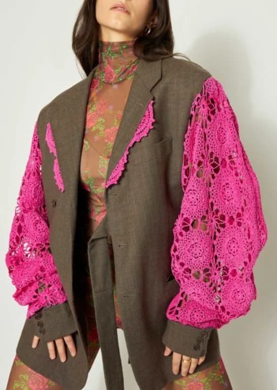 A brown tailored jacket with its sleeves replaced in bright pink lace